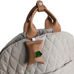 A handmade poop bag pouch attached to the 3-in-1 dog travel bag via a sturdy metal ring. The pouch is compact and stylish, designed and crafted in Stockholm.